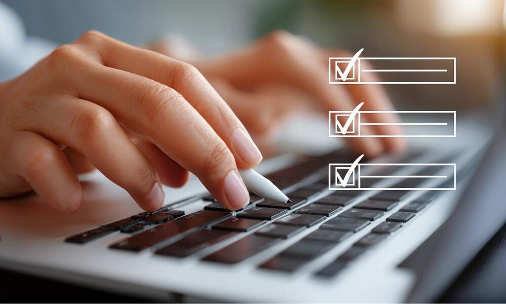 Hands typing on a laptop with a digital checklist overlay, representing FDA compliance services